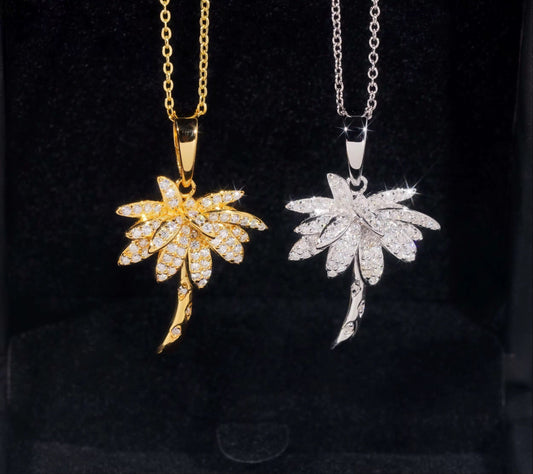 Two leaf-shaped pendants, one gold and one silver, on black background with Shining Jewel logo.